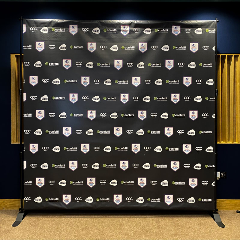 A large photo black backdrop with the logos for Confetti, British Esports.