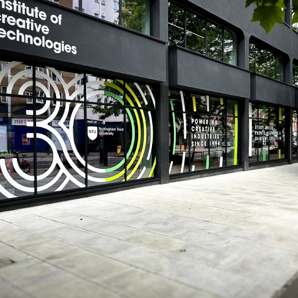 Window Graphics across street level in London. The 30 consists of a series of offset strokes to create a modern style in white with some bold green accents.
